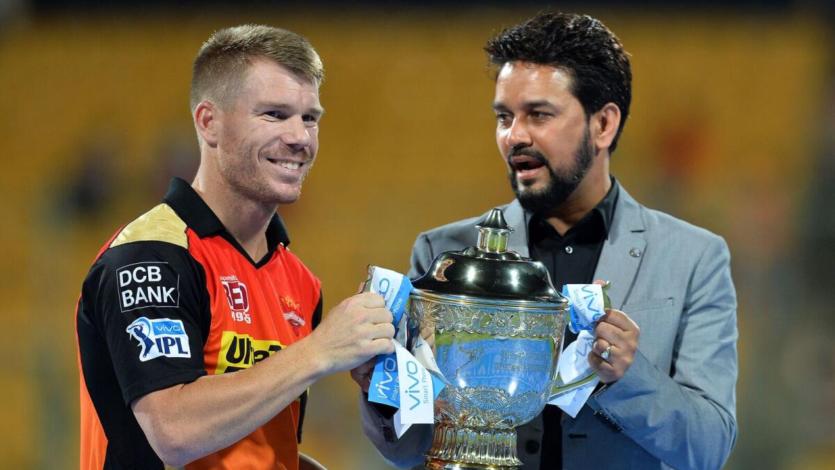 Sunrisers Hyderabad Captain David Warner (L) collects the trophy from BCCI president Anurag Thakur after the team's victory against Royal Challengers Bangalore in the final Twenty20 cricket match of the 2016 Indian Premier League (IPL) between Royal Challengers Bangalore and Sunrisers Hyderabad at The M. Chinnaswamy Stadium in Bangalore on May 29, 2016. AFP