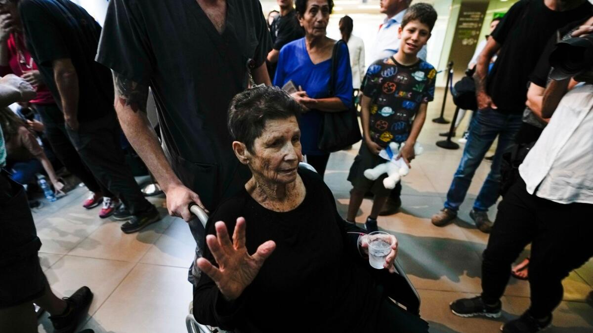 Yocheved Lifshitz, 85, who was held hostage in Gaza, waves to the media, a day after being released by Hamas. — AP
