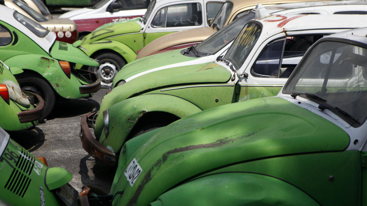 Old Volkswagen beetle taxis sit at a junk yard in Mexico City.
