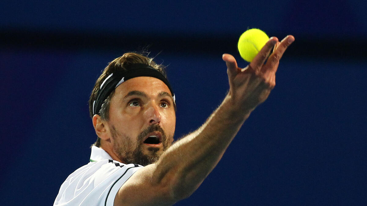 Goran Ivanisevic serves against Marat Safin. (Right) Dustin Brown during his mixed doubles match in the IPTL at the Dubai Tennis Stadium on Wednesday.