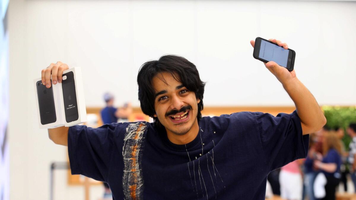 Ahmad Al Hajri from Saudi Arabia, the first walk-in customer to get the iPhone 7, shows his purchase at Mall of the Emirates in Dubai on Saturday. 
