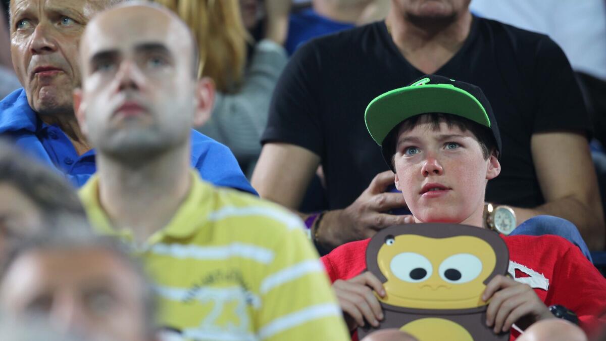 I GOT A FUNNY CHARACTER WITH ME... A young spectators holds a cartoon character in his hand during the Novak Djokovic and Tommy Robredo to start  in the Dubai Duty Free Tennis Championships at Dubai Tennis Stadium on Monday, 22 February 2016. Photo by Kiran Prasad