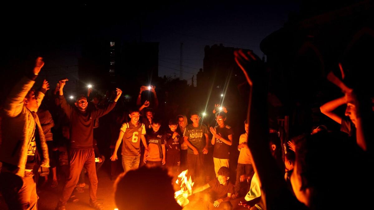 Palestinians celebrate in a street in Rafah after Hamas announced it has accepted a truce proposal. — Photo: AFP