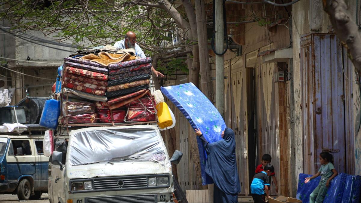Palestinians load a vehicle with belongings as they move to safer areas in Rafah, in the southern Gaza Strip. — AFP