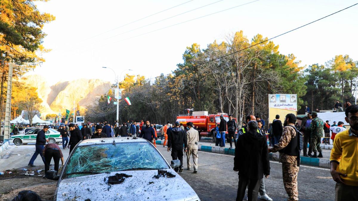 People gather at the site of an explosion in the city of Kerman. — AP