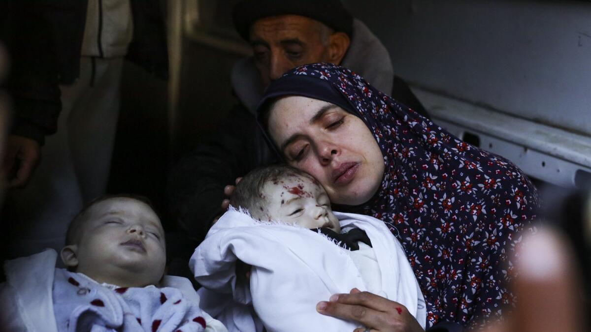 Rania Abu Anza cradles her twins, who were killed in an Israel strike on a house in Rafah. — AP