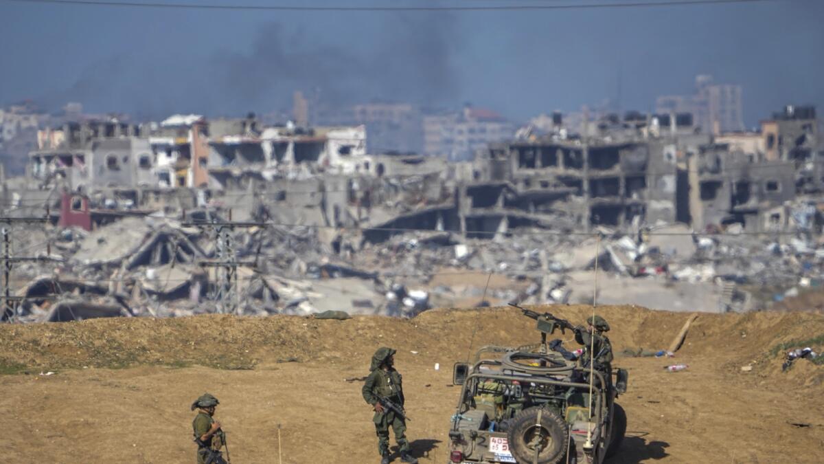 Israeli army troops are seen near the Gaza Strip border. — AP