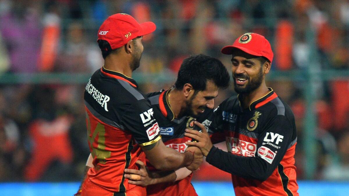 Royal Challengers Bangalore fielder Yuzvendra Chahal (C) celebrates with teammates after the dismissal of Sunrisers Hyderabad batsman Bipul Sharma, during the final Twenty20 cricket match of the 2016 Indian Premier League (IPL) between Royal Challengers Bangalore and Sunrisers Hyderabad at The M. Chinnaswamy Stadium in Bangalore on May 29, 2016. AFP