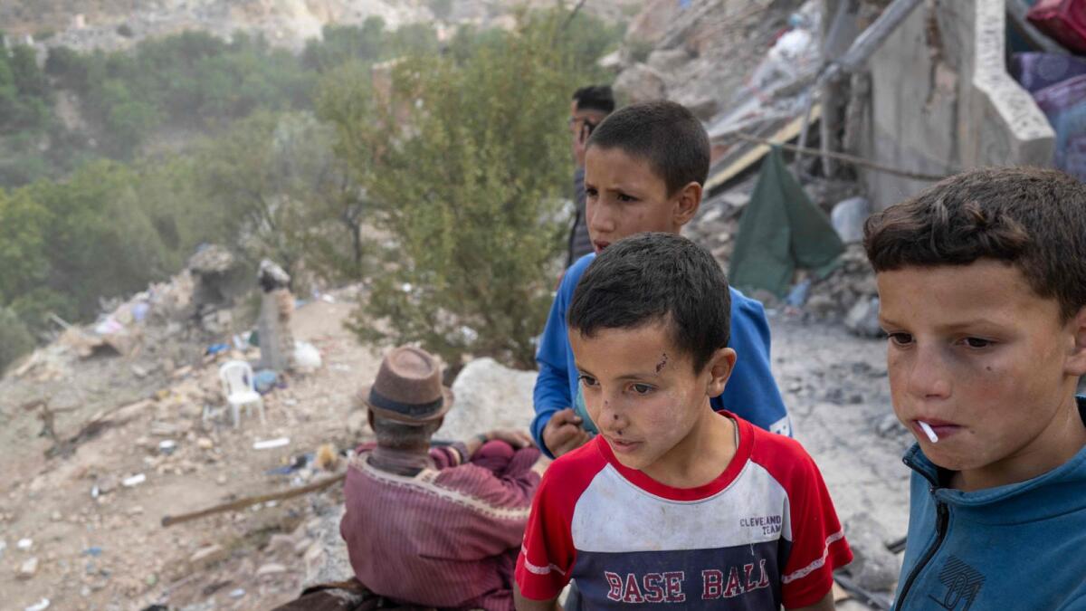 Displaced boys watch rescue operations in the village of Imi N'Tala, near Amizmiz, on September 12, 2023 four days after the deadly 6.8-magnitude earthquake. — AFP