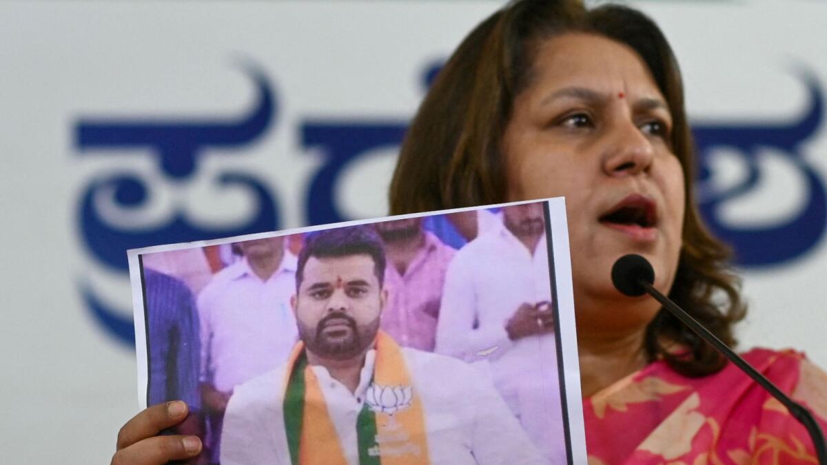 Congress spokesperson Supriya Shrinate shows a photograph featuring JD(S) MP Prajwal Revanna at a press conference in Bengaluru. — AFP file