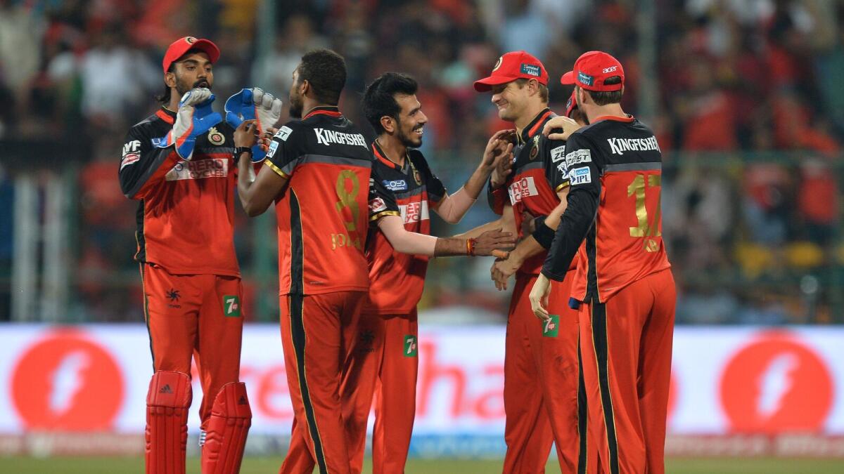Royal Challengers Bangalore bowler Chris Jordan (2L) celebrates with teammates after the wicket of Sunrisers Hyderabad batsman Yuvraj Singh during the final Twenty20 cricket match of the 2016 Indian Premier League (IPL) between Royal Challengers Bangalore and Sunrisers Hyderabad at The M. Chinnaswamy Stadium in Bangalore on May 29, 2016. AFP