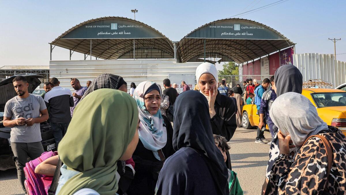 Travellers wait at the Rafah border crossing with Egypt in the southern Gaza Strip on November 1. — AFP