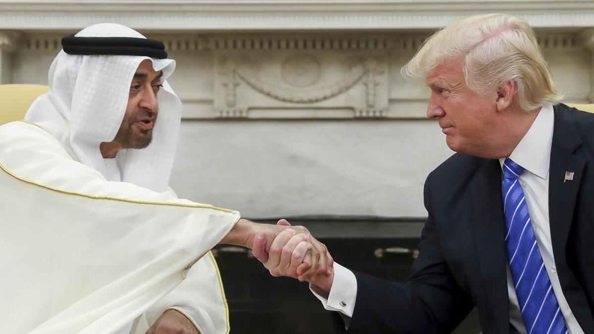 Mohamed bin Zayed shakes hands with President Donald Trump.