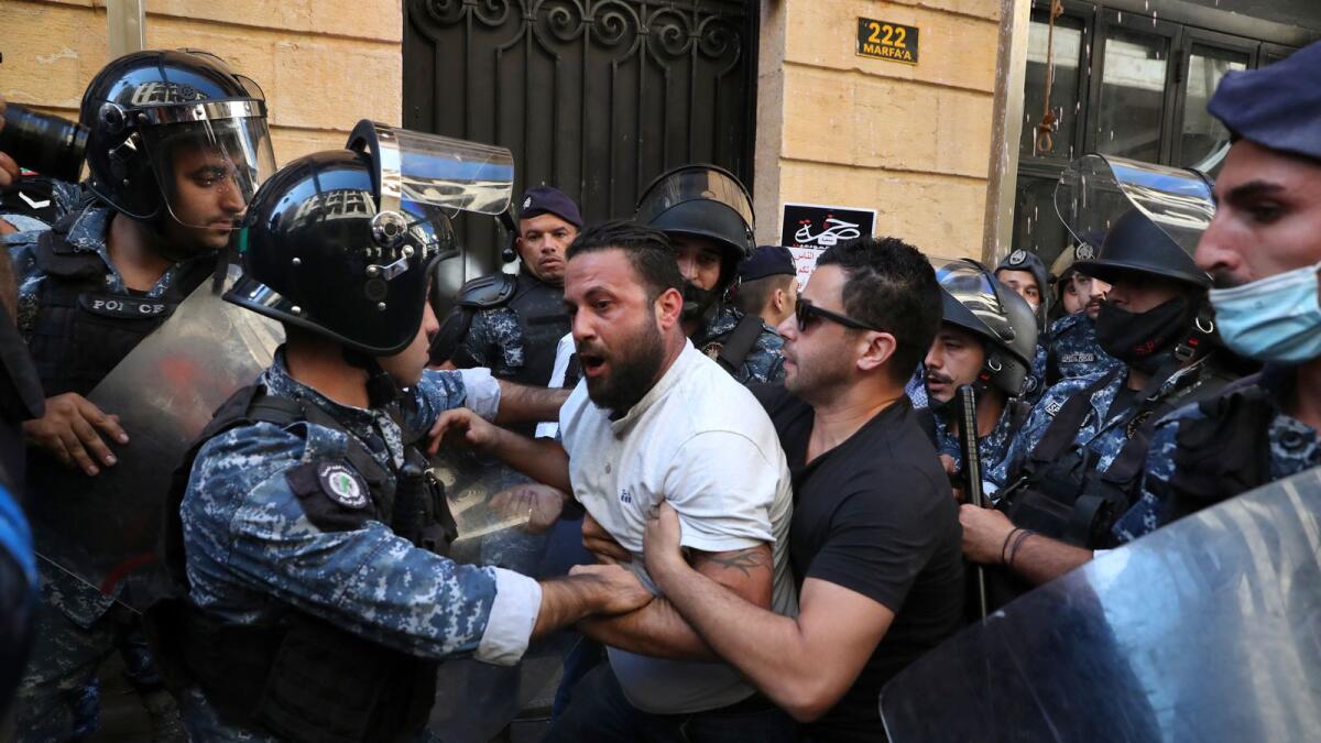 Customers scuffle with riot police as they try to storm a bank in Beirut, Lebanon,  on Wednesday, Oct. 6, 2021.-- AP file