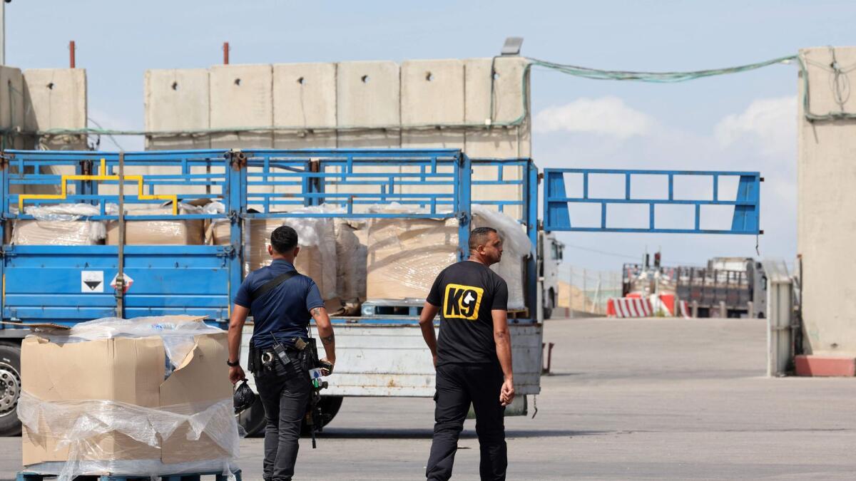 Trucks carrying humanitarian aid slated for Gaza await clearance at the Kerem Shalom (Karm Abu Salem) border crossing. — AFP