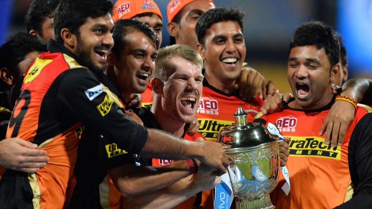 Sunrisers Hyderabad team poses for a photograph as the players celebrate their victory against Royal Challengers Bangalore after the trophy presentation in the final Twenty20 cricket match of the 2016 Indian Premier League (IPL) between Royal Challengers Bangalore and Sunrisers Hyderabad at The M. Chinnaswamy Stadium in Bangalore on May 29, 2016. AFP