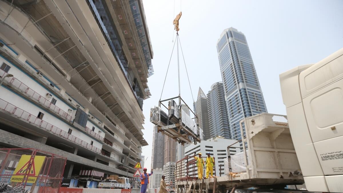 Workers are seen at a construction site in Dubai. - AFP file