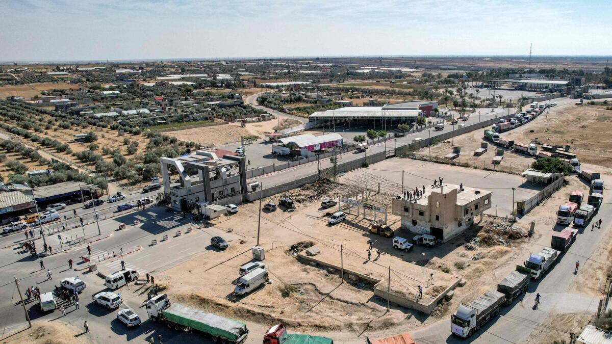 Humanitarian aid trucks cross into the Palestinian side of the Rafah border crossing with northeastern Egypt's North Sinai province. — AFP