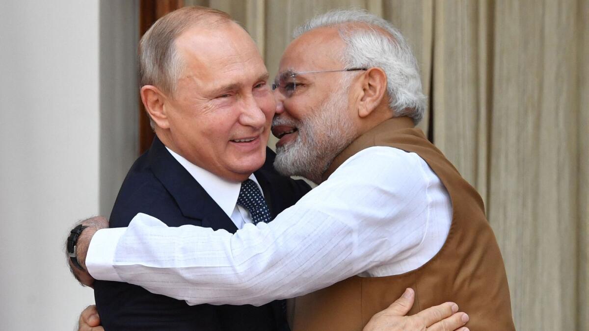 Indian Prime Minister Narendra Modi (R) welcomes Russian President Vladimir Putin prior to their meeting at Hyderabad House in New Delhi on October 5, 2018. — AFP FILE