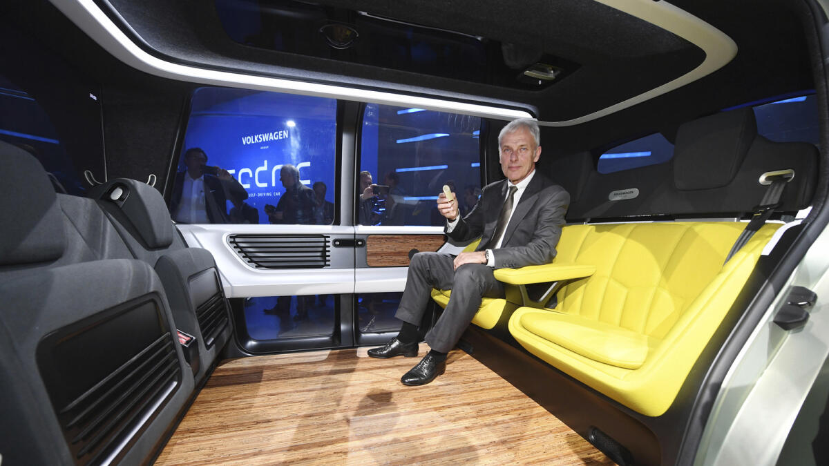Matthias Mueller, the CEO of Volkswagen, sits inside the VW autonomous concept car Sedric, during a presentation at the 87th Geneva International Motor Show in Geneva, Switzerland, Monday March 6, 2017. AP