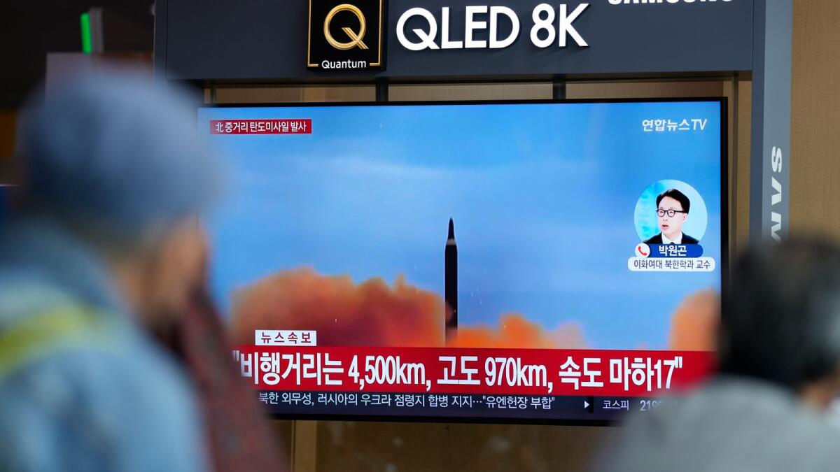 A TV screen shows a news programme reporting about North Korea's missile launch with file footage. – AP