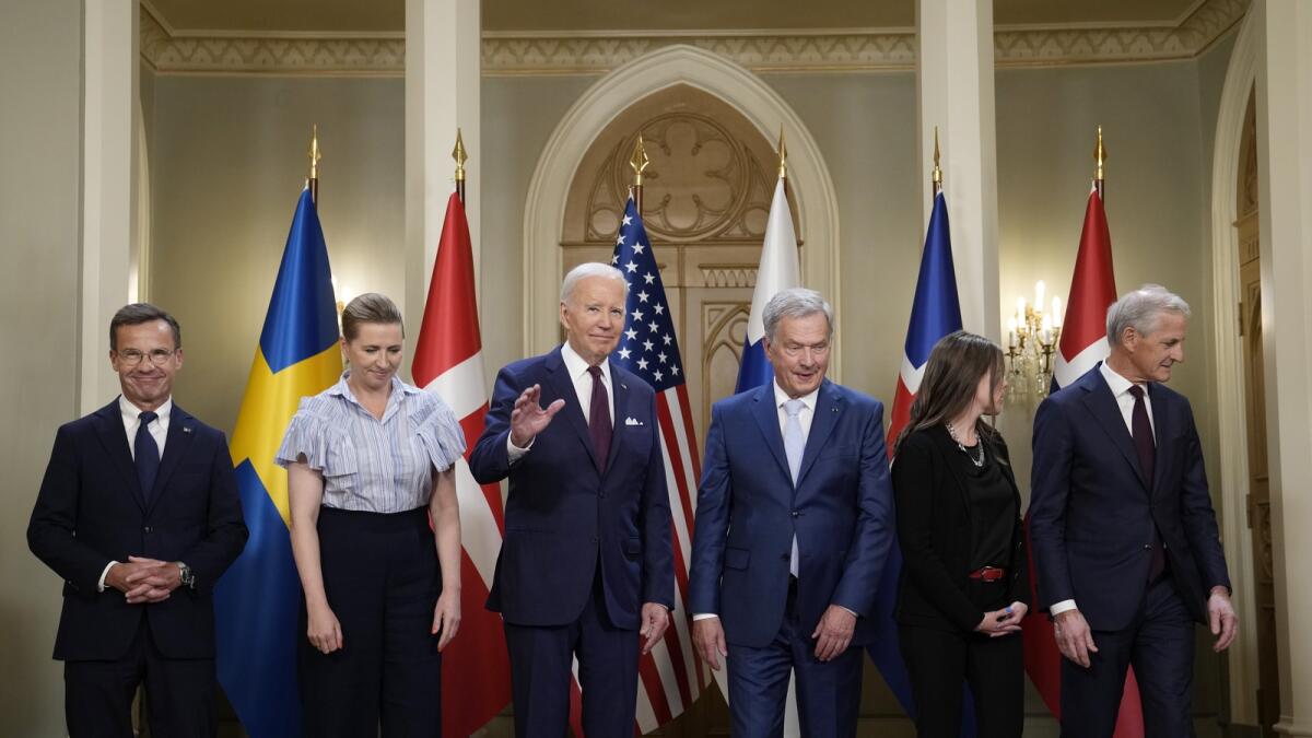 Joe Biden waves following a family photo with Nordic leaders from left, Sweden's Prime Minister Ulf Kristersson, Denmark's Prime Minister Mette Frederiksen, Biden, Finland's President Sauli Niinisto, Iceland's Prime Minister Katrin Jakobsdottir and Norway's Prime Minister Jonas Gahr Store, at the Presidential Palace in Helsinki. — AP