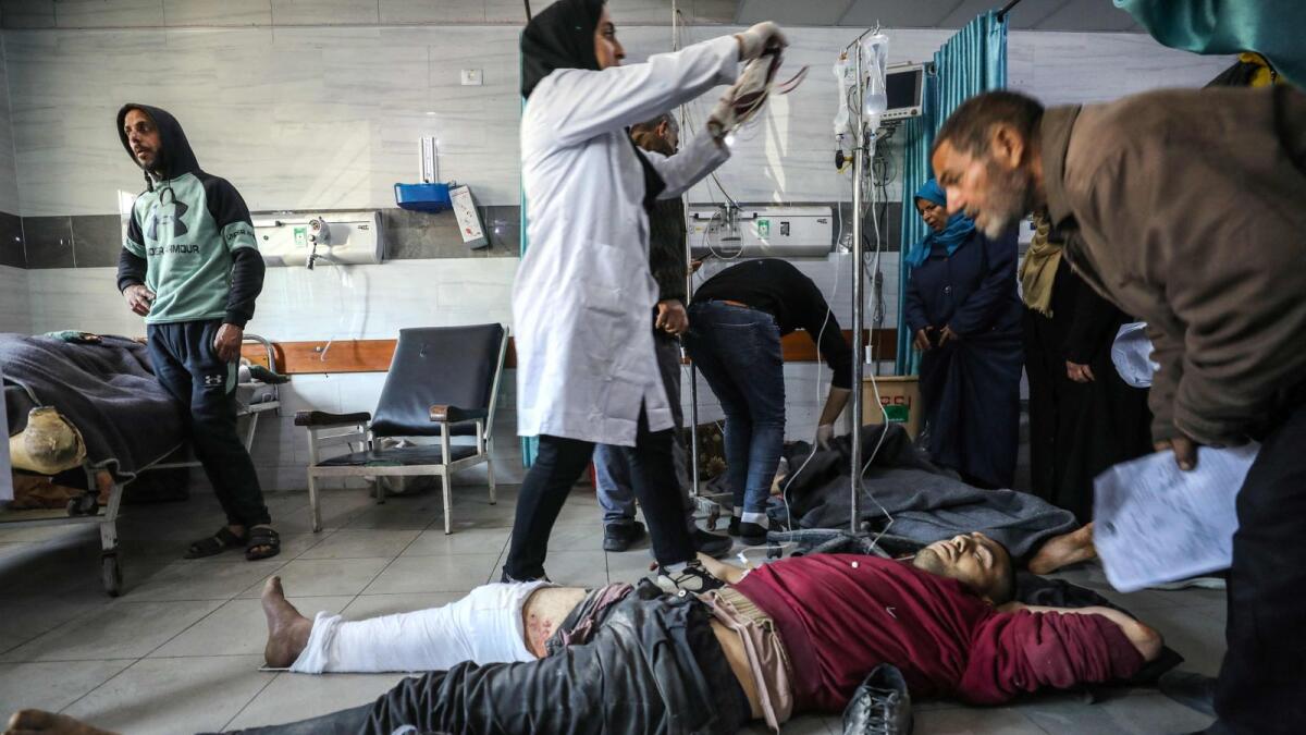 Palestinians receive medical care at Kamal Edwan Hospital in Beit Lahia, in the northern Gaza Strip, after Israeli soldiers opened fire at Gaza residents who rushed towards trucks loaded with humanitarian aid. — AFP