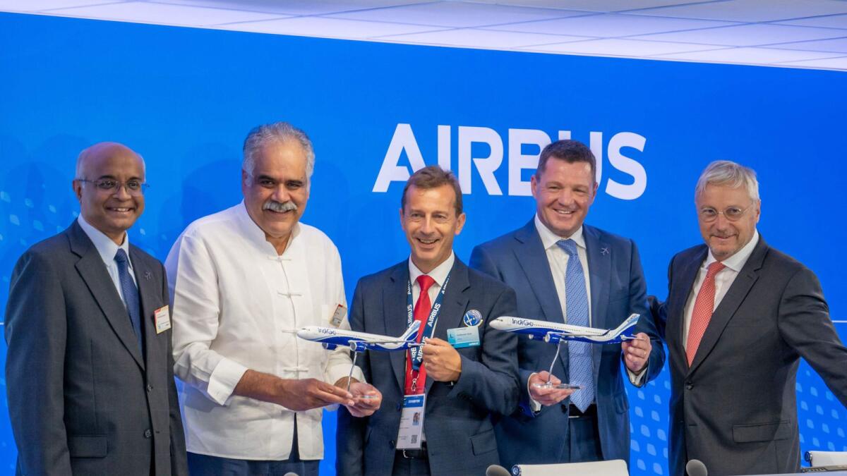 (From left) Celeris Technologies Chairman Venkataramani Sumantran, InterGlobe Enterprises chief executive officer Rahul Bhatia, Airbus chief executive officer Guillaume Faury, IndiGo chief executive officer Pieter Elbers, Airbus chief commercial officer Christian Scherer posing with model aeroplanes during a contract signing ceremony on the opening day of the International Paris Air Show on Monday. — AFP