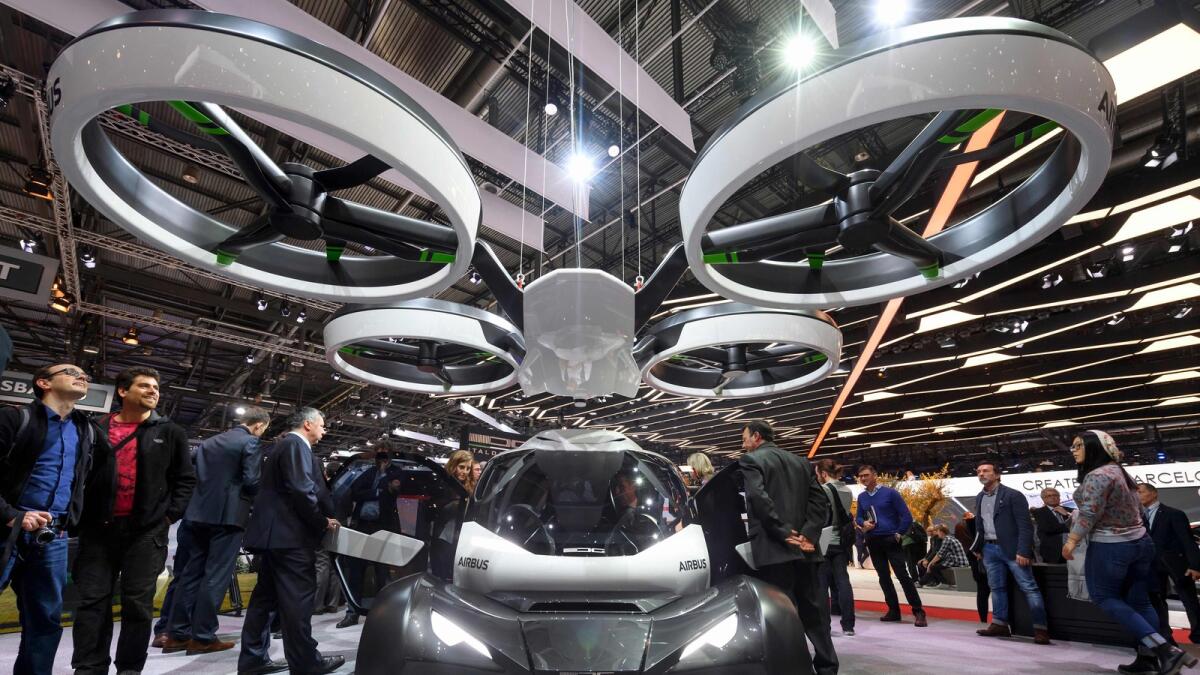 People look at the Pop.Up concept, a trailblazing modular ground and air passenger concept vehicle system by Italdesign and Airbus on the second press day of the Geneva International Motor Show on March 8, 2017 in Geneva. AFP