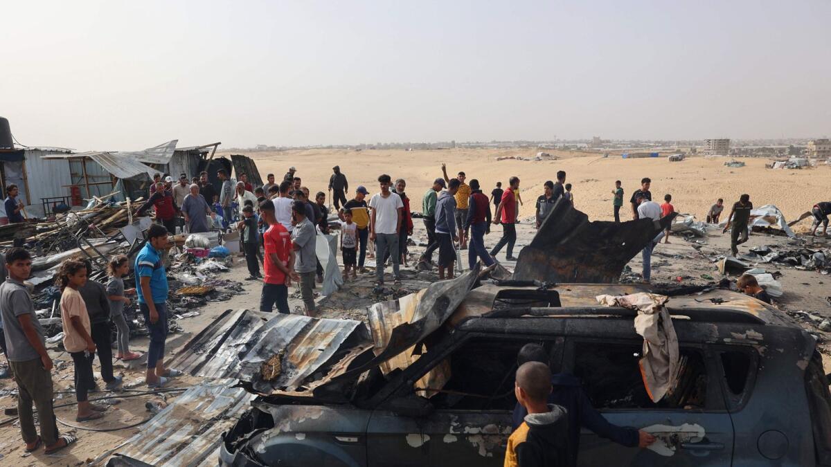 Palestinians gather at the site of an Israeli strike on a camp for internally displaced people in Rafah on May 27, 2024. Photo: AFP