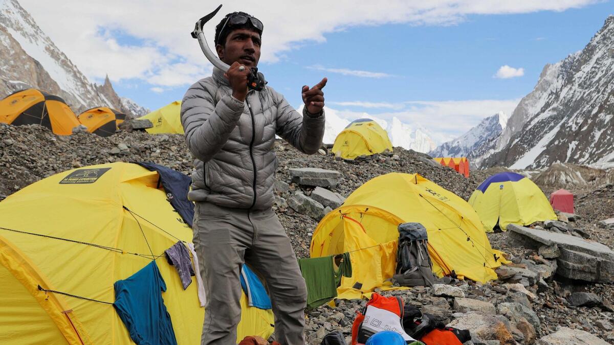Sajid Ali Sadpara holding his climbing gear at K2 Basecamp, world’s second tallest mountain in the Karakoram range of Gilgit–Baltistan, Pakistan.  -- A