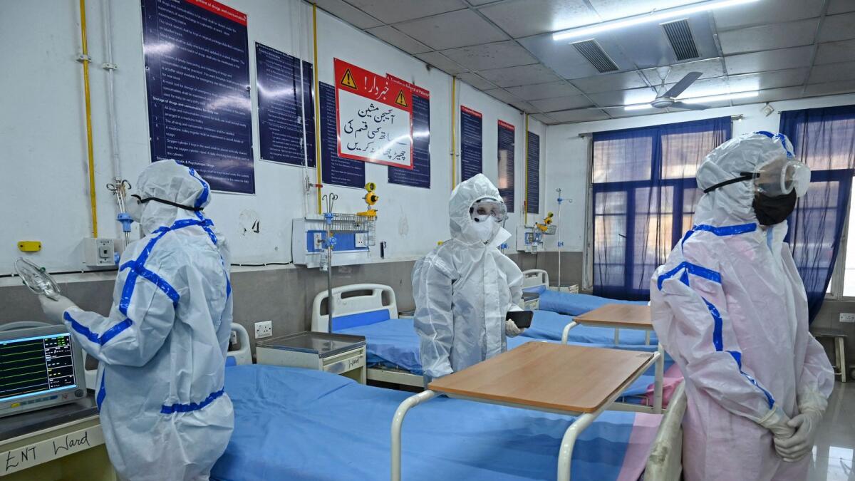 Health workers wearing personal protective equipment (PPE) take part in a mock drill to check preparations of Covid-19 facilities at JLNM hospital in downtown Srinagar. AFP file photo