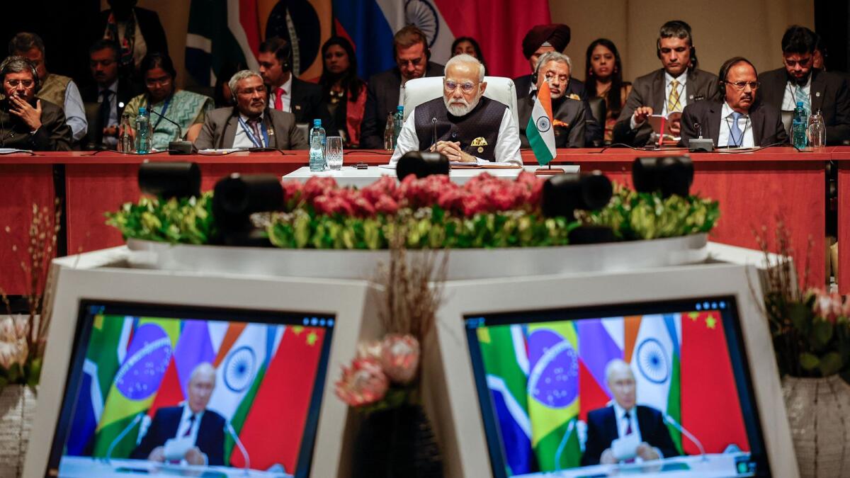 Prime Minister of India Narendra Modi  at the plenary session as Russian President Vladimir Putin delivers his remarks virtually during the 2023 Brics Summit at the Sandton Convention Centre in Johannesburg on Wednesday. — AFP