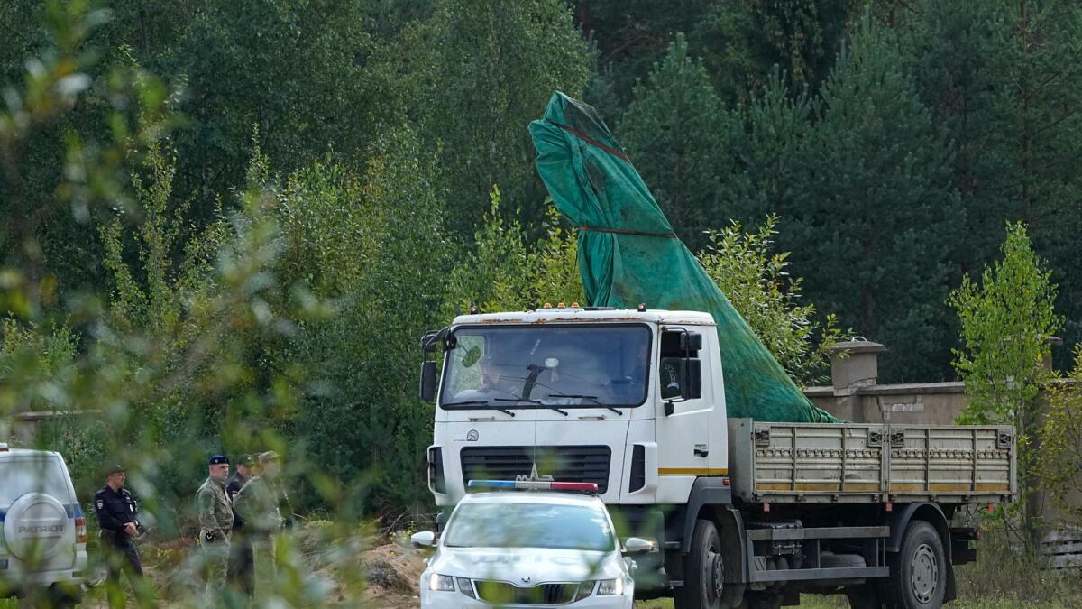 A truck carries a part of a private jet crashed near the village of Kuzhenkino, Tver region, Russia. — AP