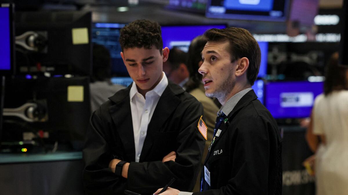 Traders work on the floor at the New York Stock Exchange. On June 18, the S&amp;P 500 reached a historic milestone, surpassing 5,487 points. — Reuters file