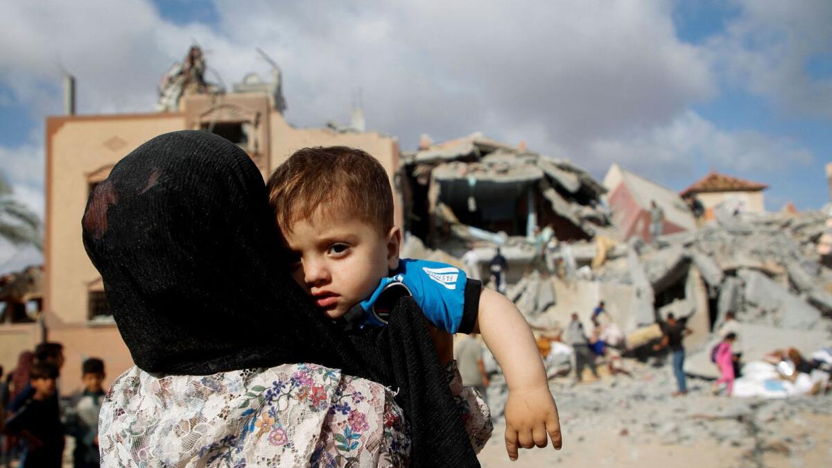 A Palestinian child looks on at the site of an Israeli strike on a house in Rafah. — Reuters