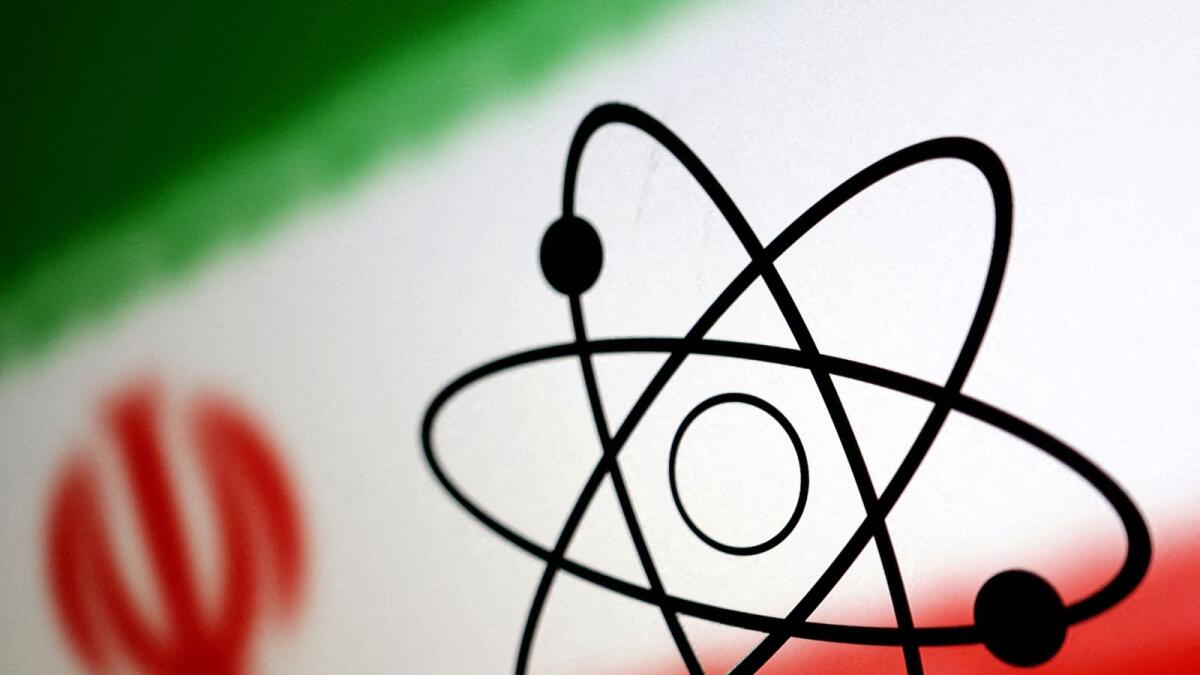 The atomic symbol and the Iranian flag are seen in this illustration. — Reuters