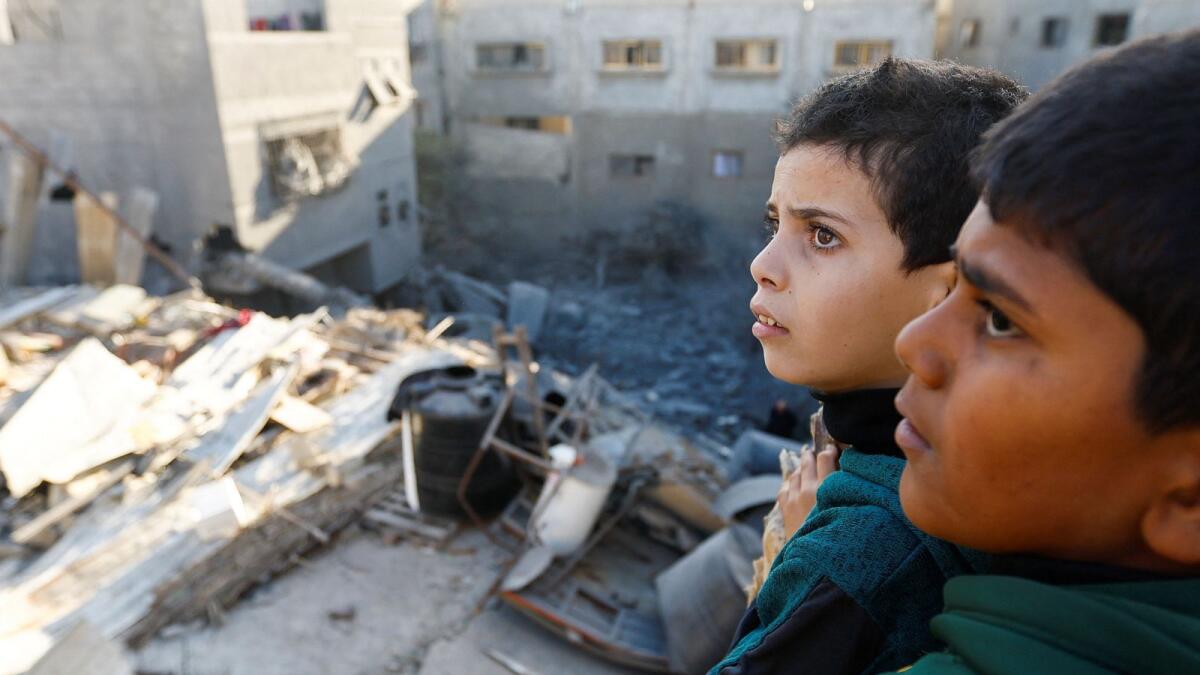 Palestinian children look at the damage at the site of Israeli strikes on houses in Khan Younis in the southern Gaza Strip. — Reuters