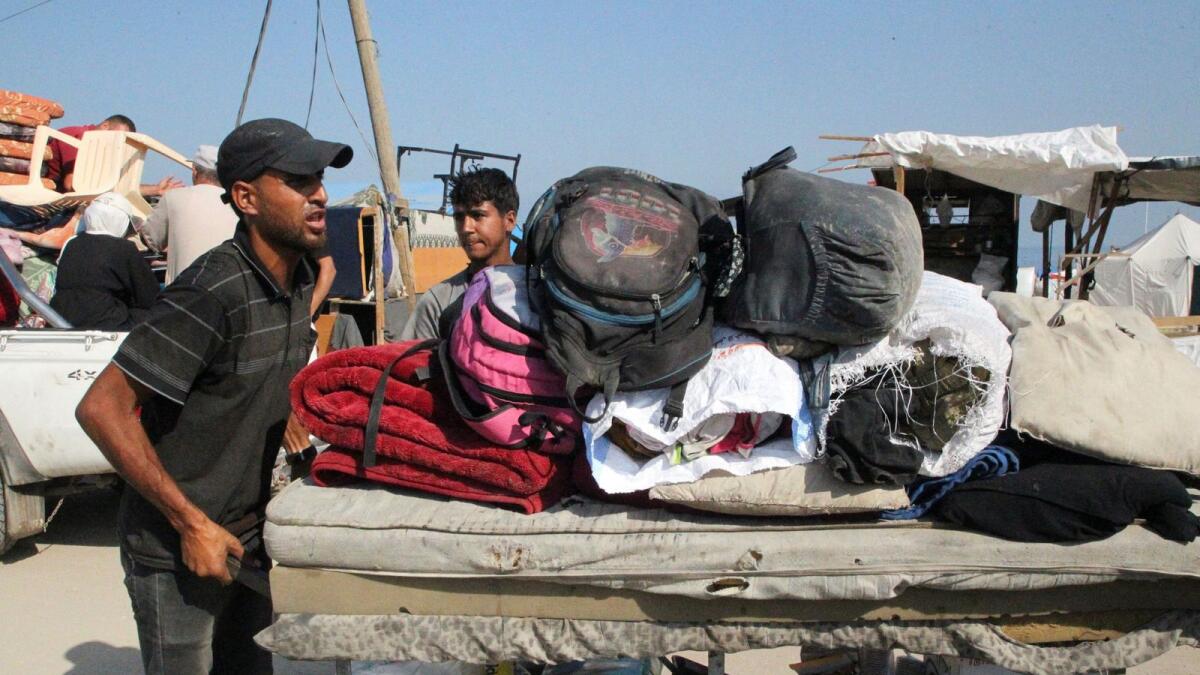Palestinians travel on foot with their belongings as they flee Rafah due to an Israeli military operation in Rafah. — Photo: Reuters
