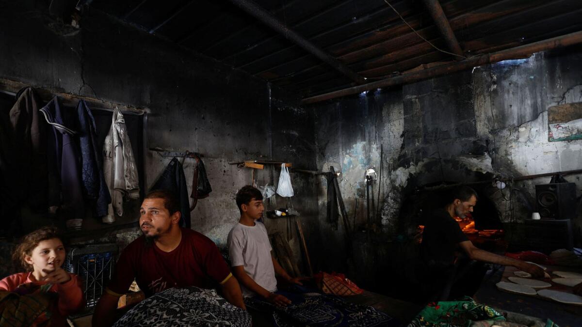 Palestinians bake bread on firewoods, amid fuel and power shortages in Khan Younis in the southern Gaza Strip. — Reuters