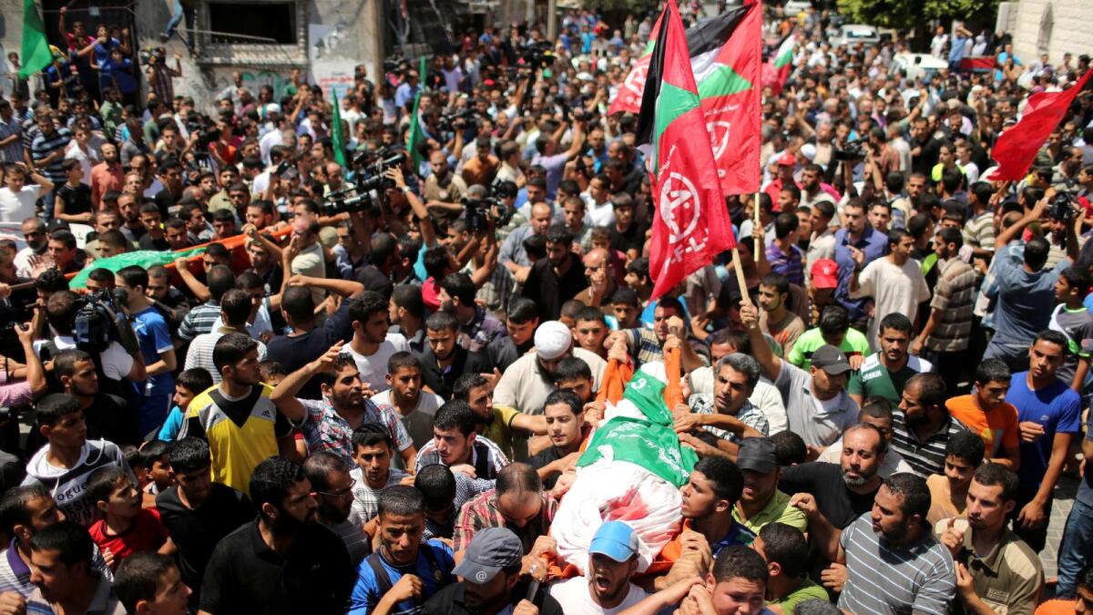Palestinians march during the funeral of the wife of Hamas's military leader, Mohammed Deif, his infant son Ali and other Palestinians whom medics said were killed in Israeli air strikes, in the northern Gaza Strip on August 20, 2014.— Reuters file