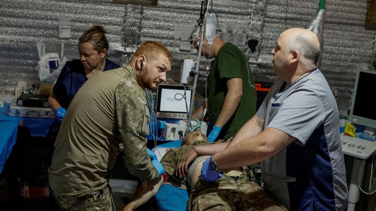 FILE PHOTO: Medics help a wounded Ukrainian serviceman inside a medical stabilisation point of the 5th Separate Assault Kyiv Brigade, amid Russia's attack on Ukraine, near the town of Chasiv Yar, in Donetsk region, Ukraine on Monday. REUTERS