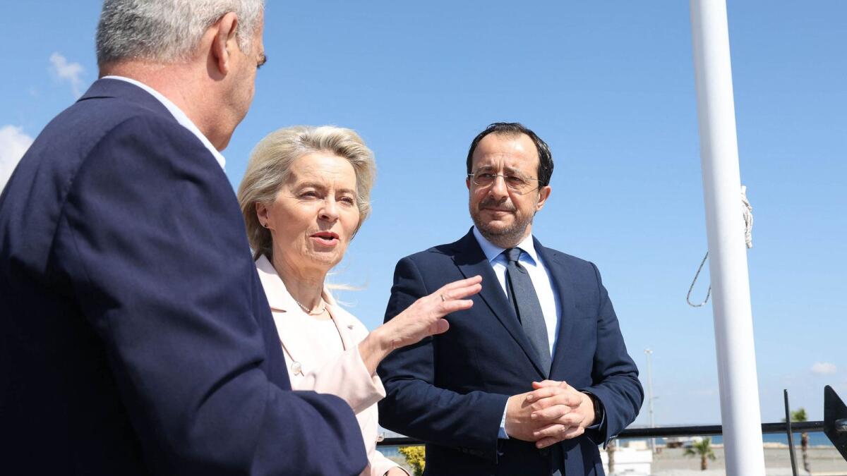 Cyprus' President Nikos Christodoulides (right) and president of the European Commission Ursula von der Leyen (centre) inspect the Larnaca Port, where a ship is awaiting permission to deliver aid to Gaza. — Photo: AFP