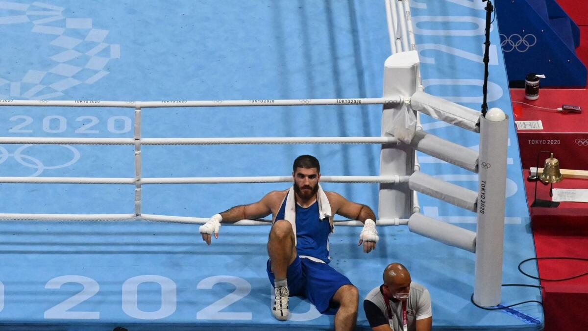 France's Mourad Aliev waits outside the ring after losing by disqualification against Britain's Frazer Clarke during their men's super heavy (over 91kg) quarterfinal boxing match. — AFP