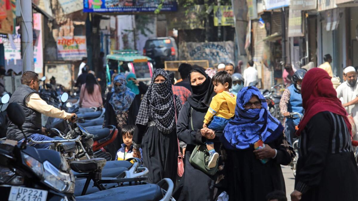 Muslim women make their way through a busy market area near the Jama Masjid  Rampur in India's Uttar Pradesh state. — AFP
