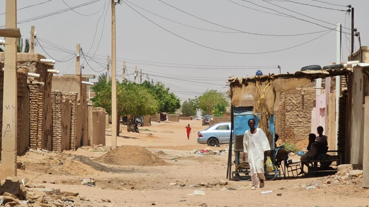 A man walks in a street in Khartoum. — AFP