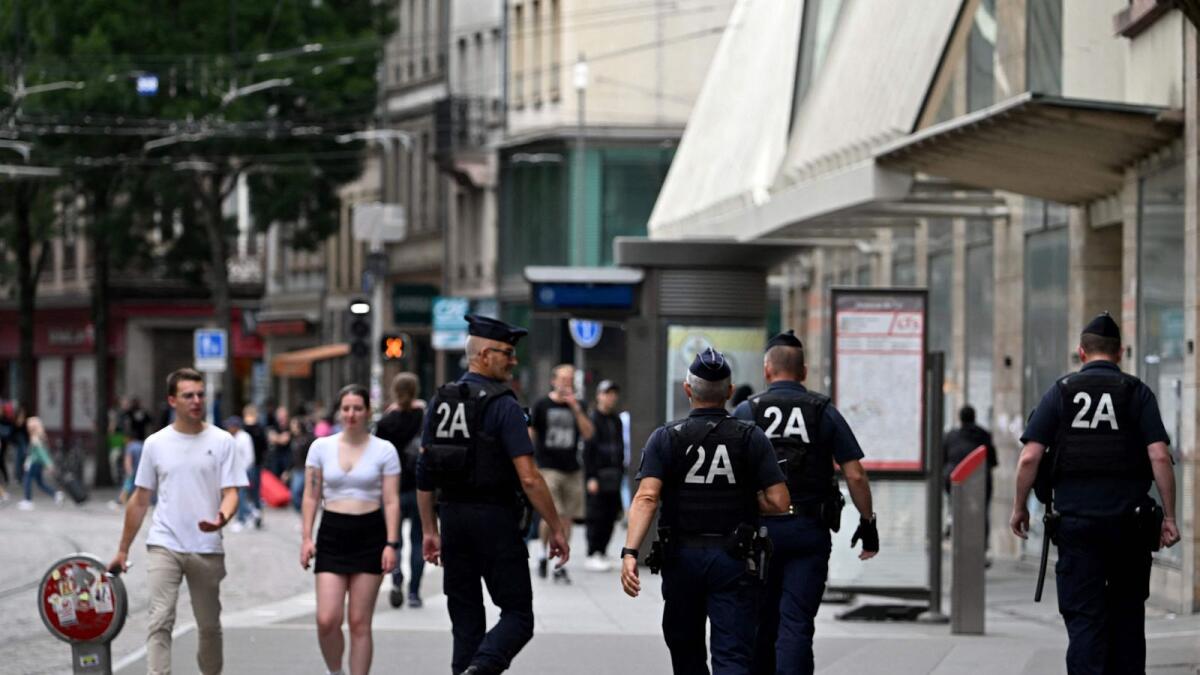 Riot police monitor a commercial street following a fourth consecutive night of rioting in France sparked by the death of teenage driver Nahel by a police bullet, in Strasbourg. - AFP