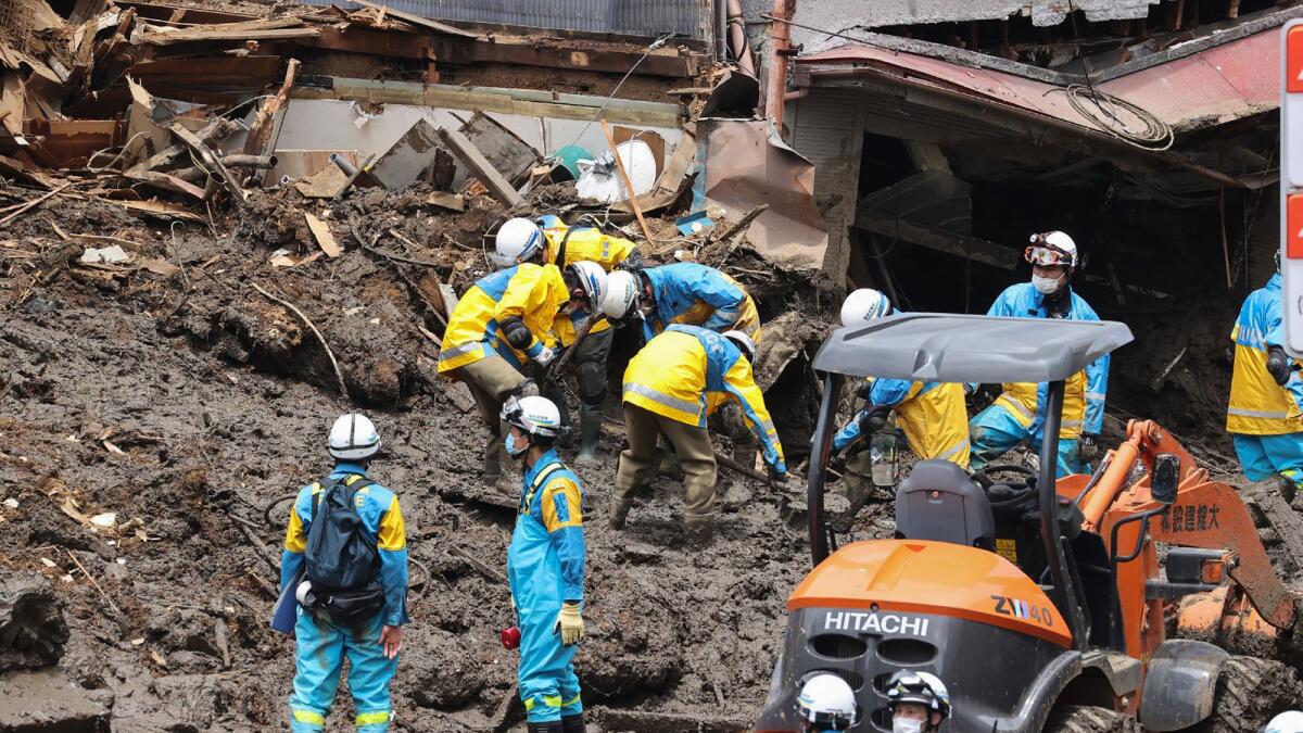 Police search for missing people at the scene of a landslide in Atami. Photo: AFP