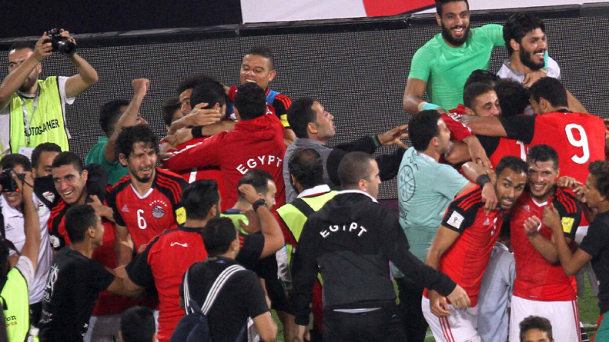 Egypt's team players celebrate wining against Congo's team during their World Cup 2018 Africa qualifying match between Egypt and Congo at the Borg el-Arab stadium in Alexandria on October 8, 2017.