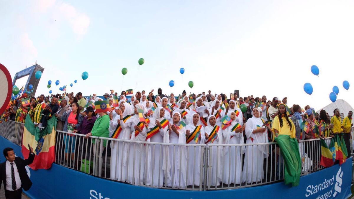 Spectators cheer for their participants at Dubai Marathon 2016.